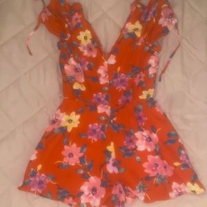bright red romper with floral designs . second layer underneath . size: S . $12